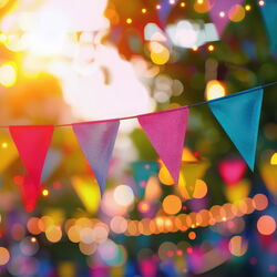 beautiful blurred background of a festive city street with colorful flags and garlands in pink and blue colors AdobeStock_845357814